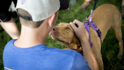 Patrick Schmidt greets a nearby dog, Ginger, during the 2018 Husker DogFest at the University of Nebraska–Lincoln. This year’s DogFest — the first since the COVID-19 pandemic — is Oct. 7.